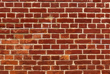 Obraz premium Full frame shot of a weathered old red brick wall with white joints, suitable as a background texture not only for architectural or historic topics