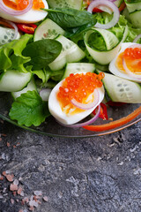 fresh  gourmet salad with red salmon caviar and chuka,  eggs and vegetables. close up.  delicacy  healthy food.