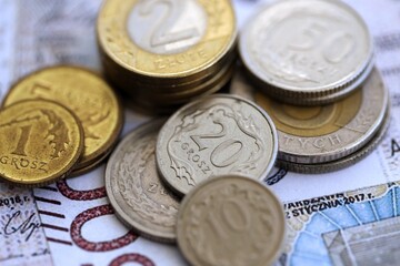 Big amount of polish zloty money banknotes and grosz coins close up. Huge pile of cash of Poland currency. Concept of business, economy and investment in Poland