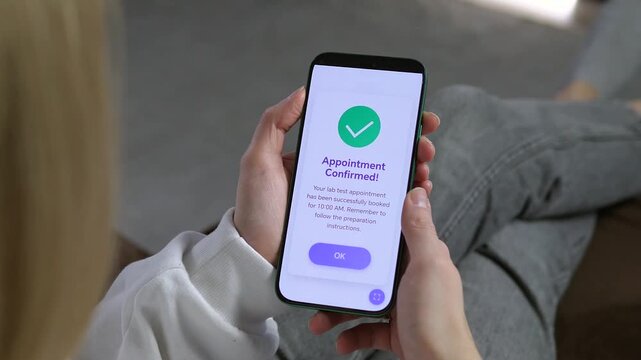 Seamless medical booking experience: a woman confirms a clinic appointment via mobile app. Closeup of Appointment Confirmed screen with a green checkmark. Perfect for showcasing healthcare software