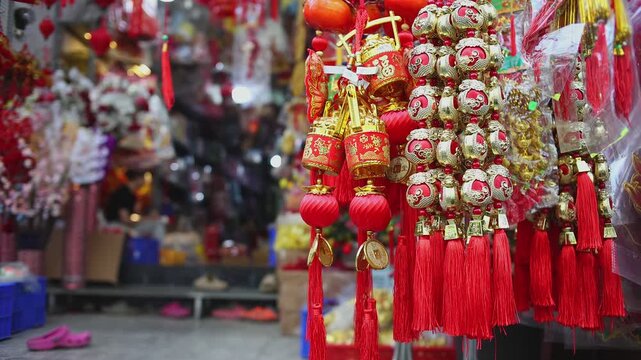 Colorful red and golden decorative elements sold on an vietnamese street market prior to the Tet holiday or Lunar new year in Vietnam, Asia. Selective focus close up video.