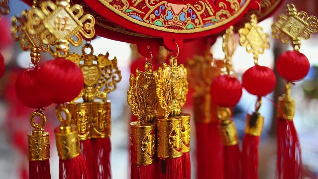 Colorful red and golden decorative elements sold on an vietnamese street market prior to the Tet holiday or Lunar new year in Vietnam, Asia. Selective focus close up video.