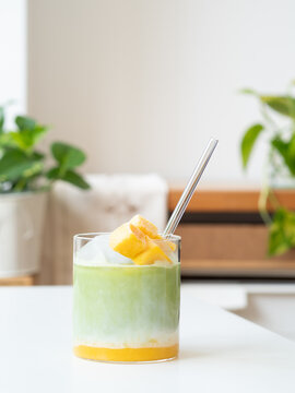Refreshing iced matcha latte with mango chunks