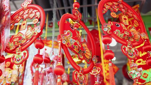 Colorful red and golden decorative elements sold on an vietnamese street market prior to the Tet holiday or Lunar new year in Vietnam, Asia. Selective focus close up video.