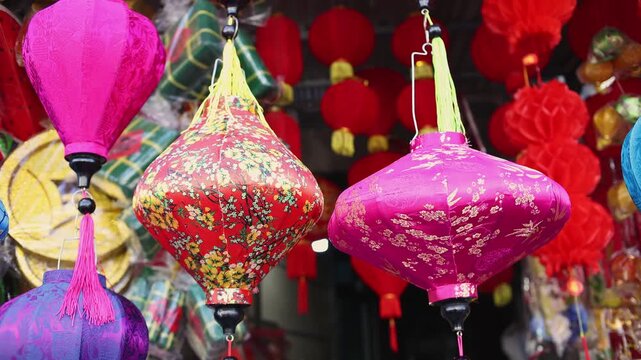 Colorful red and golden decorative elements sold on an vietnamese street market prior to the Tet holiday or Lunar new year in Vietnam, Asia. Selective focus close up video.