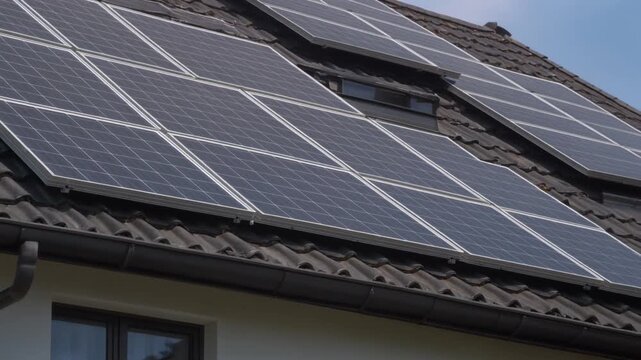 Close-up building with solar panels on the roof. Sustainable and clean energy at home
