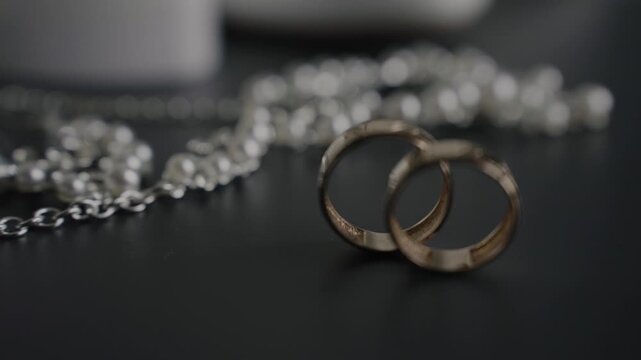 Wedding gold rings captured from an unusual angle, slow motion. Contemporary style
