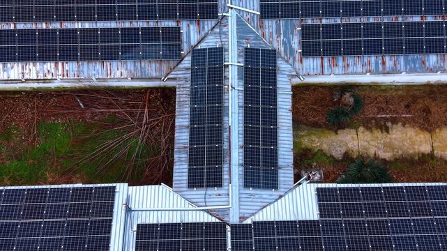 Symmetrical top view of solar panels on T-shaped roof. Overhead view of solar panel installation on a specific industrial roof geometry.
