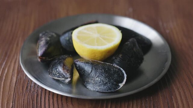 Close-Up of Turkish Stuffed Mussels Served with Lemon on Metal Plate
