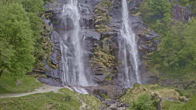Twin waterfalls that plunge into the valley, Acquafraggia waterfall, Borgonuovo, Lombardy, Italy.
