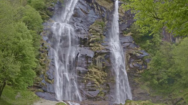 Twin waterfalls that plunge into the valley, Acquafraggia waterfall, Borgonuovo, Lombardy, Italy.