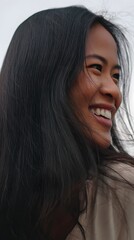 Smiling young woman with long dark hair.