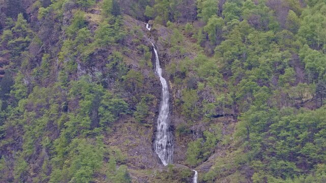 Waterfall high in the mountains, waterfall near Borgonuovo, Lombardy, Italy.