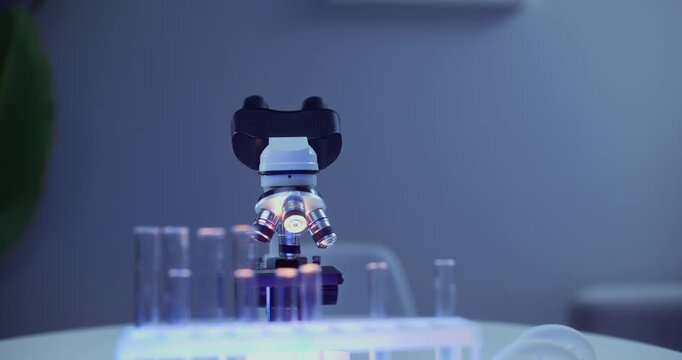 Microscope with testtubes in medical biotech laboratory.