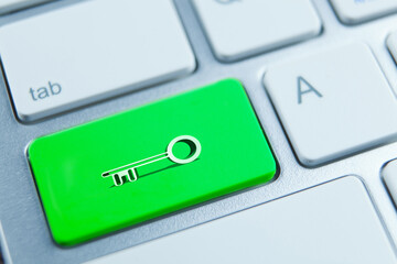 Key for internet security concept. Green key on the keyboard of the laptop.