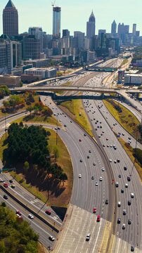 Atlanta, Georgia urban landscape with skyscraper buildings and complex highway interchange connecting interstate speedways. Advanced road design and metropolitan development concept.