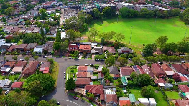 Drone panoramic aerial view of Sydney NSW Australia city Skyline and looking down on roof tops streets roads trees and parks in Suburban Sydney inner west suburbs of Burwood Ashfield Croydon Summer Hi