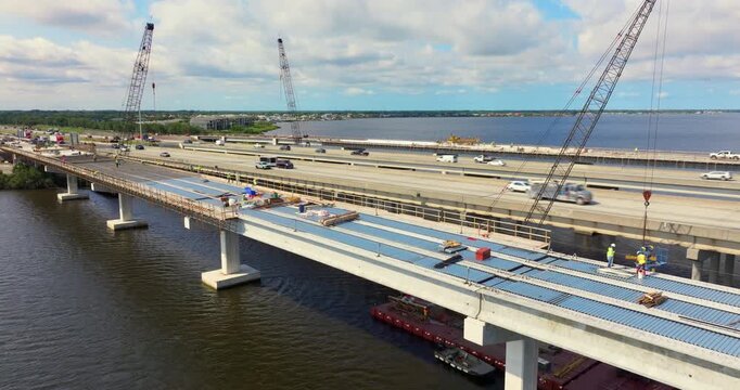 Men at work on roadworks building site. Construction of new highway bridge in Ellenton, Florida. Development of American interstate transportation infrastructure.