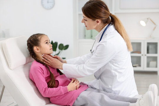 Doctor examining little girl during appointment in hospital