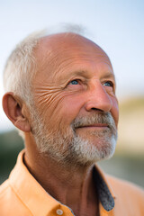**Elder's Daydream: A contemplative portrait of a senior man, his gaze lifted towards the sky, capturing a moment of quiet reflection and peaceful contemplation.**