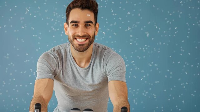 Dynamic Fitness: A man with a radiant smile is intensely focused while cycling indoors, capturing the essence of an invigorating exercise routine and healthy living.