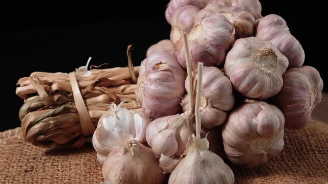Garlic in a basket on a wooden table.