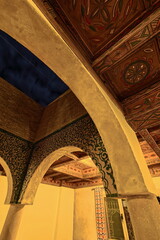 Carved wood ceiling painted in Amazigh motifs, decoration of a modern house in the Berber tradition of adobe wall, zellij tiles...Merzouga-Morocco-132