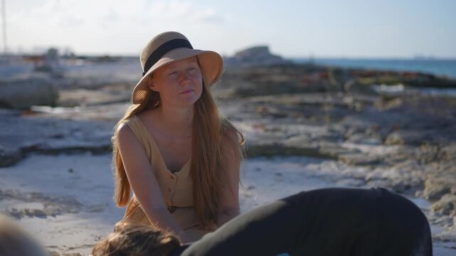 Young mom spending quality time with her two sons on a beautiful tropical beach, enjoying sunshine, laughter, and family bonding moments by the sea.