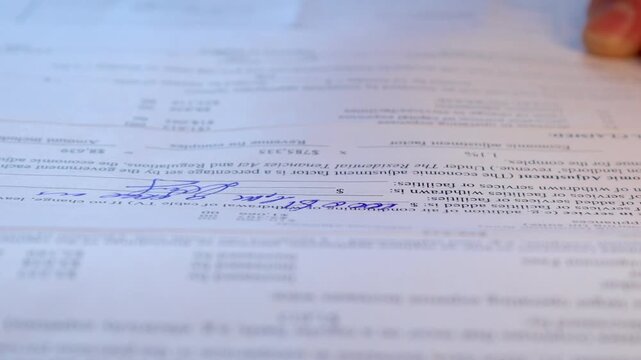Hand Signing Paper Form Closeup.hand holding blue pen marking checkboxes on tax form document, concept of financial reporting, filing, audit and personal income declaration.