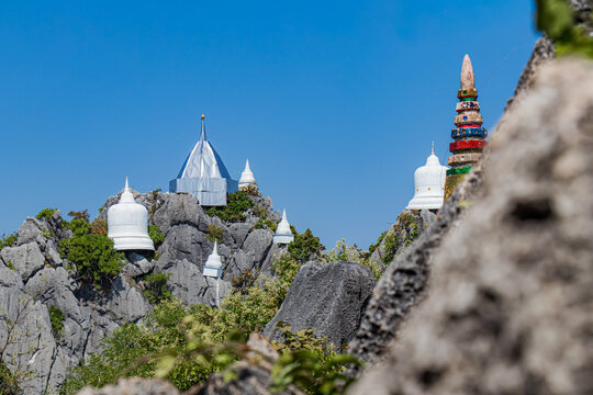 Pagodas on the top of mountains under blue sky, Chaloem Phrakiat Phrachomklao Rachanuson temple (Wat Phrabat Pu Pha Daeng) Unseen and Amazing temple in Thailand, Chae-Hom District, Lampang province.