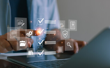 Businessman using laptop to checklist digital document management. Workflow control, file organization, approval process and secure information management for modern business and enterprise systems.
