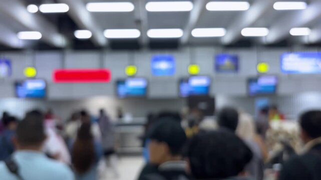 Passengers queue to board a plane at the airport terminal. Blur video.