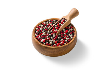 High angle view of mixed black, white and red peppercorns in wooden bowl with scoop, isolated on a...