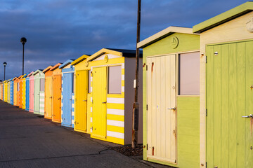 Naklejka premium Beautiful, colourful beach huts on the promenade in Seaford, East Sussex, England, on a cloudy winter day