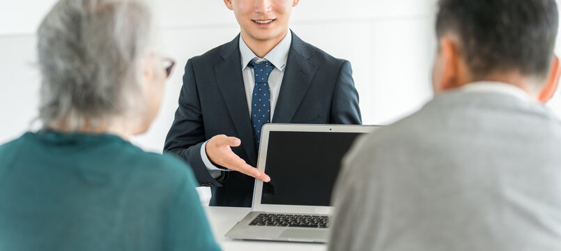 A male social worker, support counselor, life counselor, or certified social worker provides consultation and counseling to an elderly couple