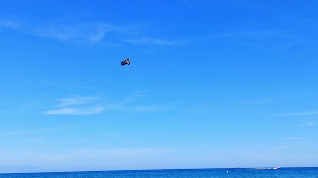 Paraglide flying in the blue sky