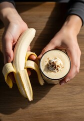 Hands Holding Fresh Banana and Creamy Smoothie on Wooden Surface