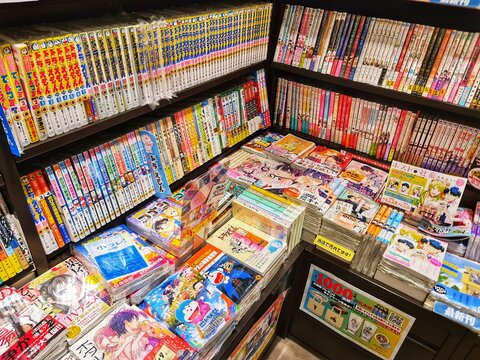Osaka, Japan on 18 Oct 2025. Colorful Comic Books Stacked on Shelves in Book Store