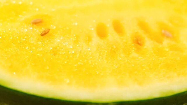 Close-up of fresh yellow watermelon slice with water droplets