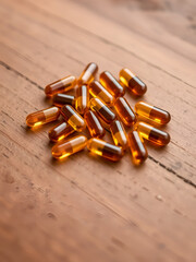 Beta alanine capsules arranged in a cluster on a textured wooden surface with warm brown tones and ample blurred background for copy space
