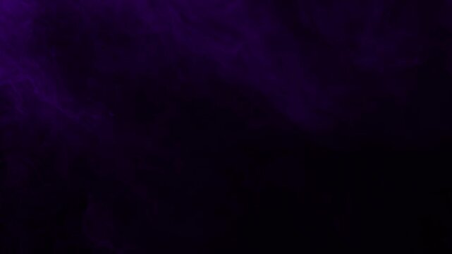 Subtle and gentle wisps of dark purple smoke drift slowly. Isolated on black background, ideal for compositing, moody titles, and mysterious scenes