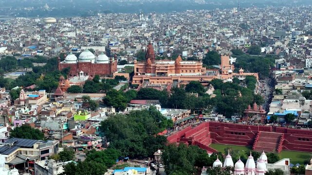 Drone video capturing Potra Kund&rsquo;s stepped water tank beside the revered Janm Bhumi temple, set within Mathura&rsquo;s historic urban sprawl. Krishna Janmasthan and Shahi Mosque Eidgah