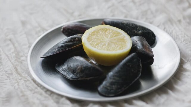 Close-Up of Turkish Stuffed Mussels Served with Lemon on Metal Plate
