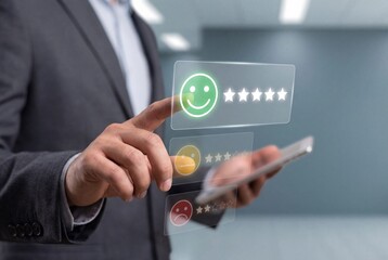 Obraz premium Businessman pressing green smiley face icon on virtual screen to give excellent customer feedback