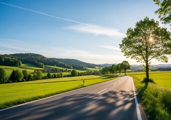 Fototapeta premium Picturesque road cuts through lush green landscape on a sunny day