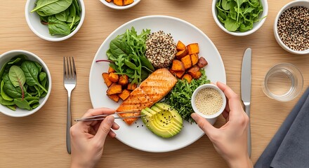 Preparing a nutritious salmon bowl with fresh ingredients on wooden table