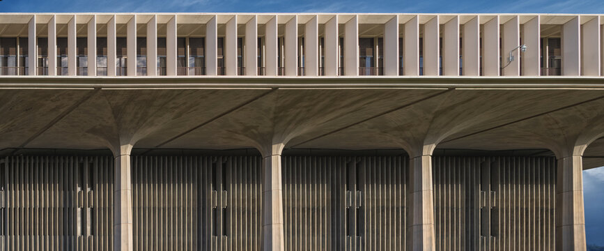 Modern Building Roofline with Blue Sky Overhead.