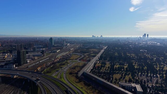 Aerial view of Milan cityscape with highway traffic and skyline