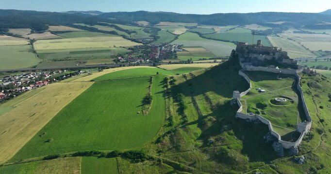 left to right panning aerial drone view of the ruins of Spis Castle in eastern Slovakia, the castle is situated above the town of Spisske Podhradie, UNESCO Heritage listed site, Spis, Slovakia, Europe
