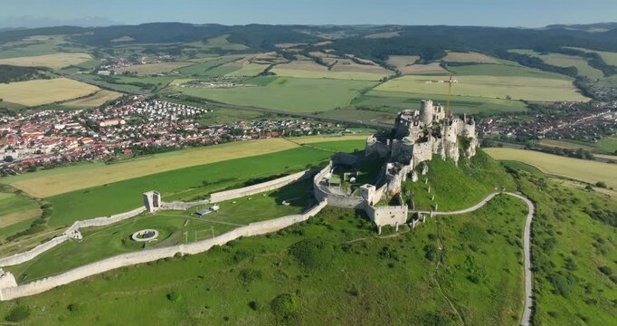 4K Pull out aerial drone motion view of the ruins of Spis Castle in eastern Slovakia, the castle is situated above the town of Spisske Podhradie, UNESCO Heritage listed site, Spis, Slovakia, Europe